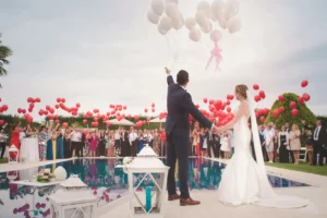 Couple celebrating wedding with balloons